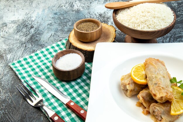 front view cabbage dolma with lemon slices on gray background color meal cuisine dinner dish meat food cooking calorie