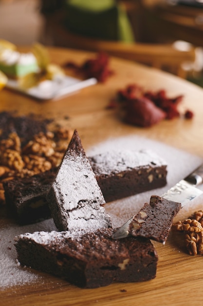 A front view choco bars along with nuts on the wooden brown floor