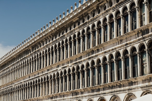 Front view closeup of white Doge's Palace white tracery facade in Venice.