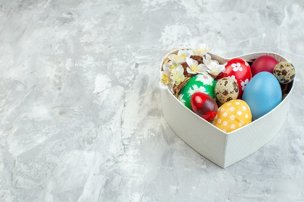 front view colored easter eggs inside heart shaped box on white background ornate femininity concept novruz colourful spring easter