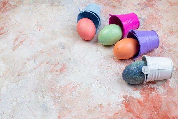 front view colored easter eggs inside separate little baskets on the light background ornate spring easter concept horizontal holiday colourful