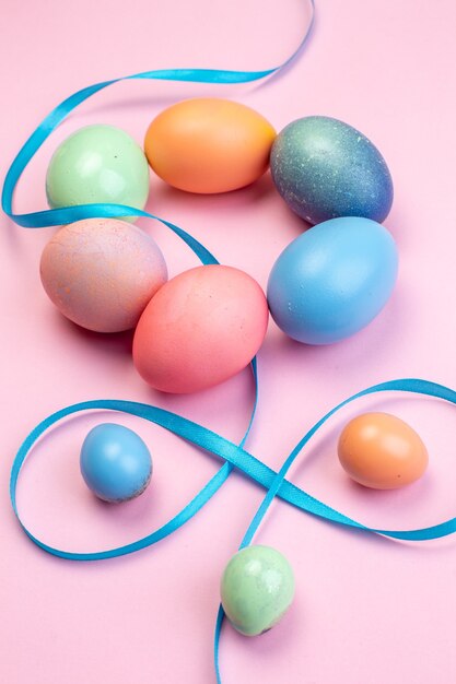 front view colored easter eggs on pink surface ethnic ornate multi colourful colours easter holiday