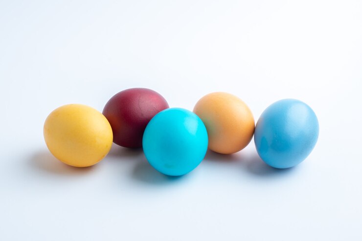 front view colored easter eggs on white surface colours easter holiday ornate multi group ethnic colourful