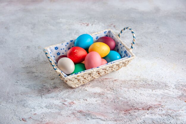 front view colored easter eggs with cute designed box on white background group colourful multi ornate colours