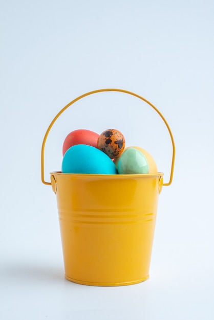 front view colored painted eggs inside basket on white background spring colourful ornate horizontal novruz