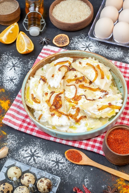 Front view cooked dough pieces with fried onions and different ingredients on the dark background dinner food oil meal cooking photo dish