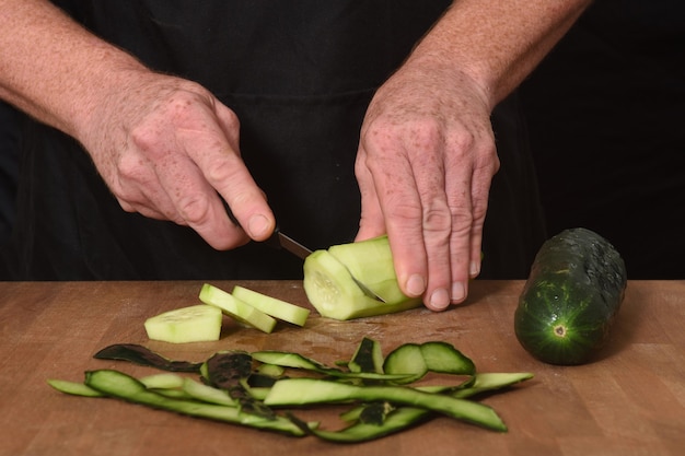 Front view of a cutting cucumber on a wood