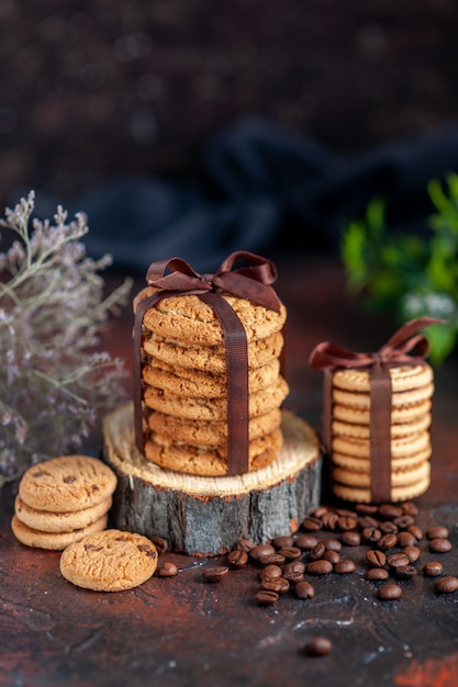 front view delicious biscuits tied with bow on dark background cake horizontal pie tea sweet cookies sugar dessert