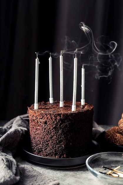 Front view of delicious chocolate cake with candles