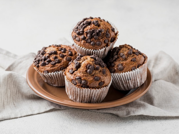 Front view delicious chocolate chips muffins on plate