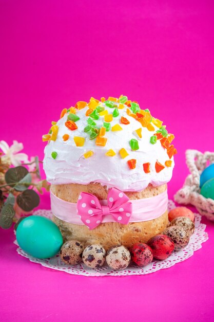 front view delicious cream cake with colored eggs on pink background sugar colourful ornate novruz sweet spring holidays dessert