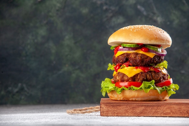 Front view of delicious homemade sandwich on wooden board on blurred surface with free space