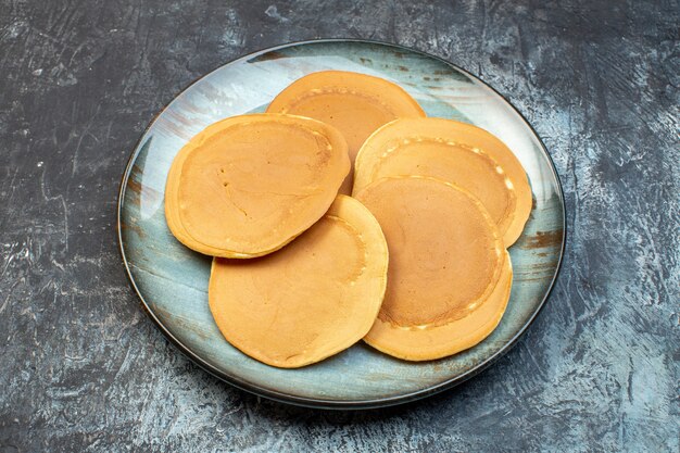 front view delicious little pancakes inside plate on gray background honey sugar breakfast morning food family bake dough jelly