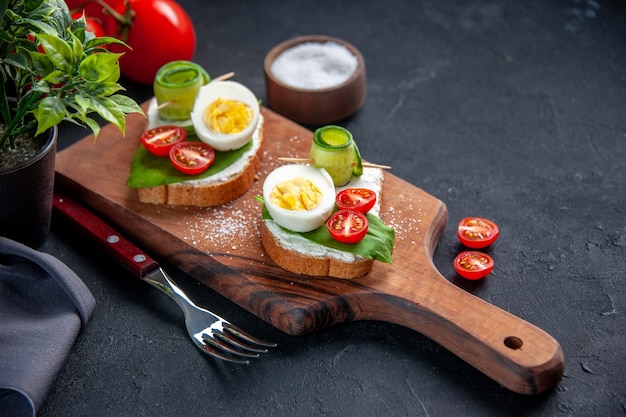 front view delicious sandwiches with tomatoes cucumbers and eggs on cutting board dark background burger food snack breakfast toast meal lunch sandwich