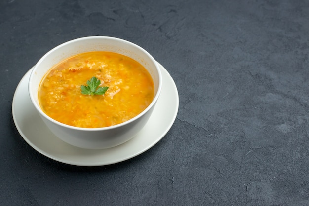 Front view delicious soup inside white plate on dark surface