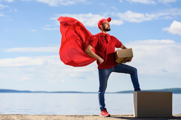 Front view delivery man wearing superhero cape