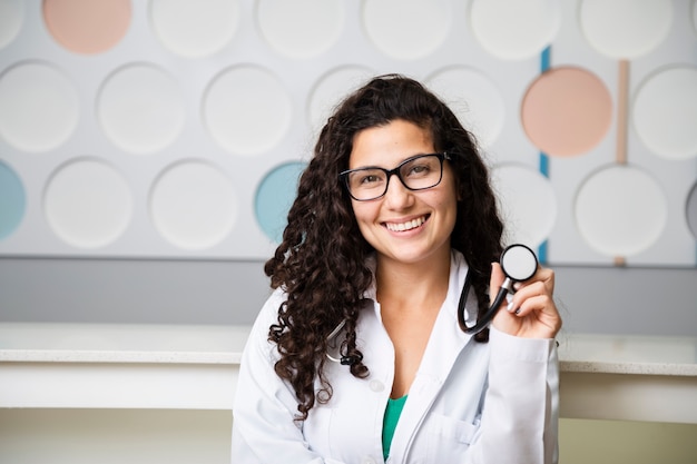 Front view doctor holding a stethoscope