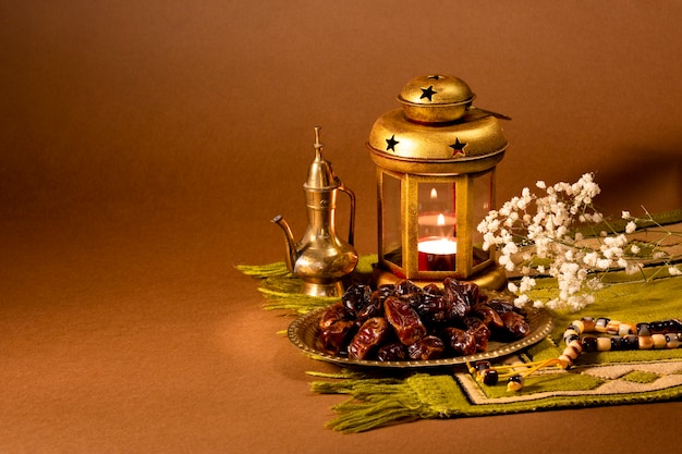 Front view of dried dates and candle holder on table