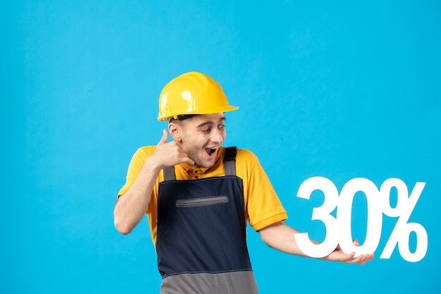 Front view excited male worker in uniform with writing on blue