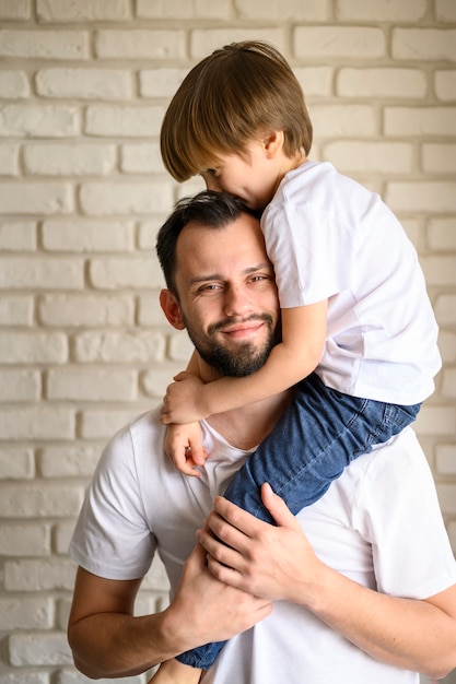 front view father holding his kid