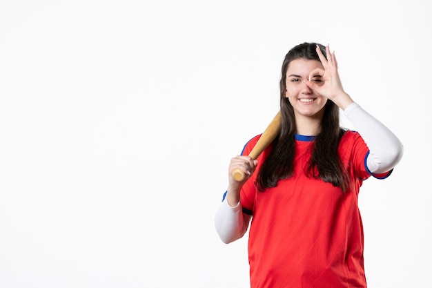 Front view female baseball player with bat and ball