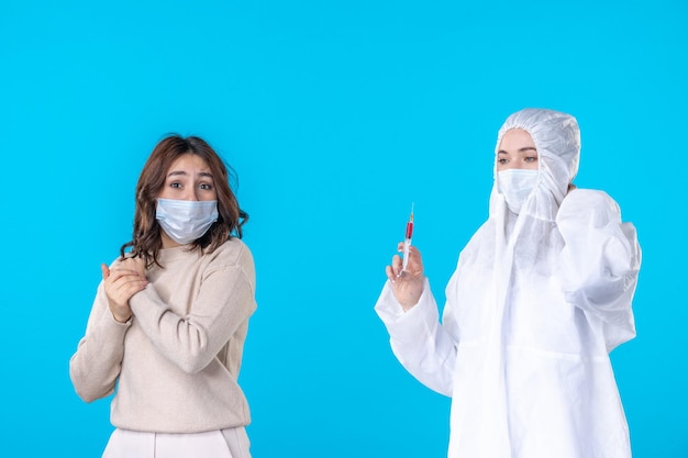 front view female doctor preparing injection for patient on blue background virus disease isolation covid- science health pandemic