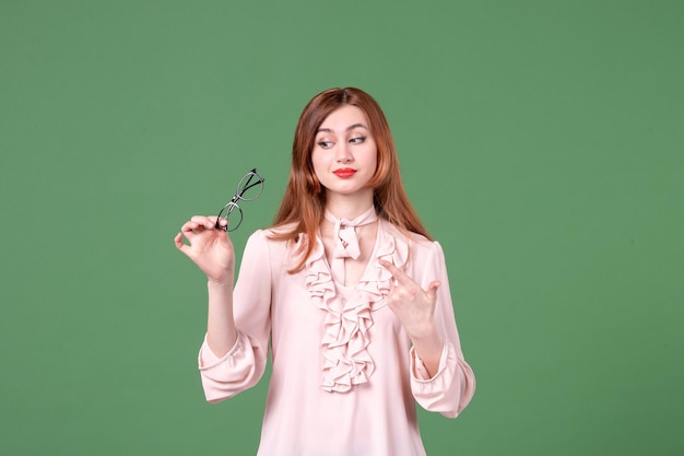 Front view female teacher in pink blouse on green