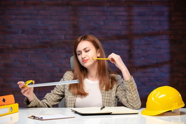 front view female worker in construction site holding tape measure agenda engineer corporate project business job plan manager