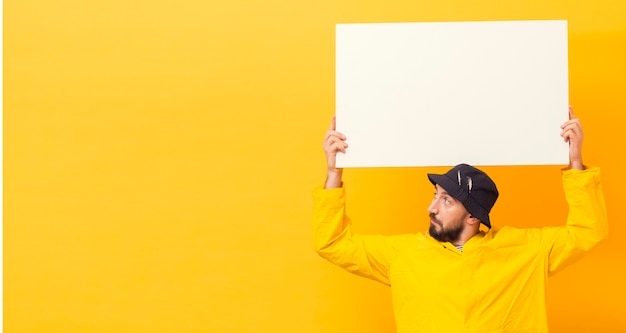 Photo front view of fisherman holding blank placard with copy space