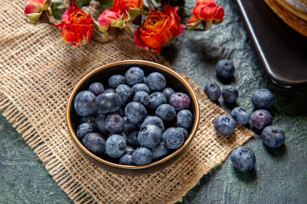 Front view fresh blueberries with delicious honey cake dark surface