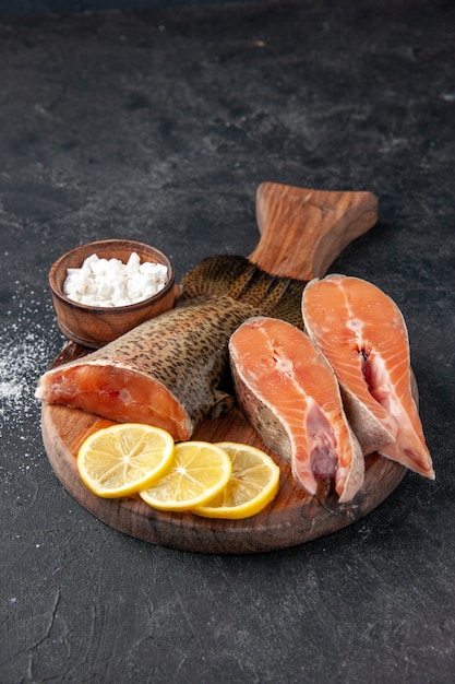 front view fresh fish with lemon slices on a dark background ocean seafood meal food meal water meat salad sea fish