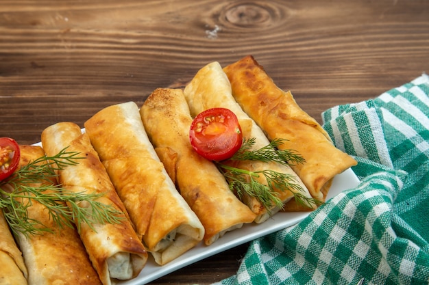 front view fried greens pastries with red tomatoes on brown background food bake bread pastry meat