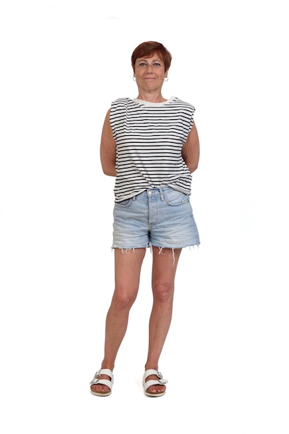 Photo front view of a full portrait of a middle aged woman looking at camera and arms on back on white background