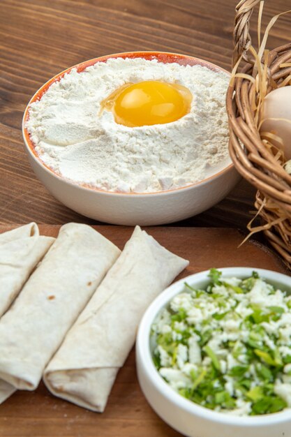 front view greens pita rolls with eggs and flour on brown background food bake cake dough cook cuisine meat