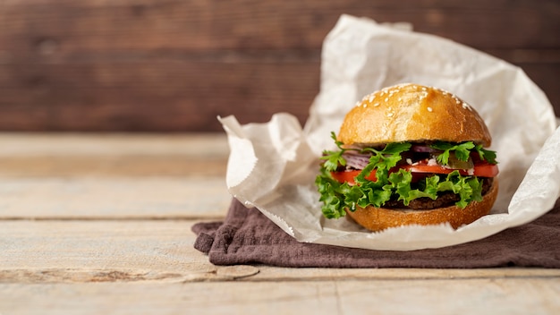 Front view hamburger with wooden background