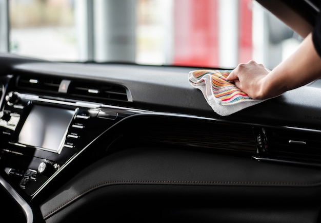 Front view hand cleaning the interior of car