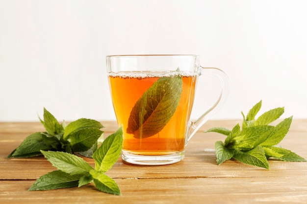 Front view of herbal tea concept on wooden table