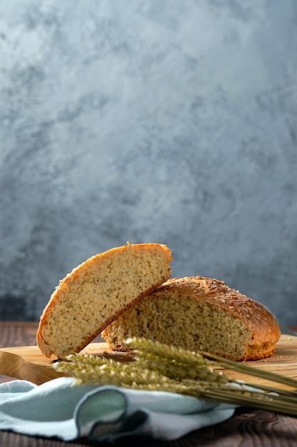 Front view of homemade wheat bread on wooden cutting board