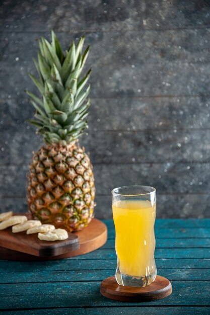 front view juice in glass on wood board fresh pineapple on wood board