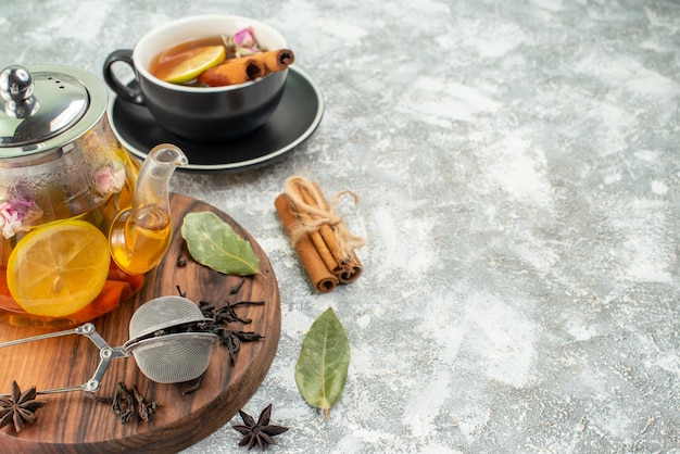 Front view kettle with tea lemon tea on light background flavor color morning breakfast food fruit ceremony flower free space