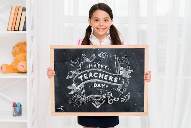 Front view kid holding blackboard