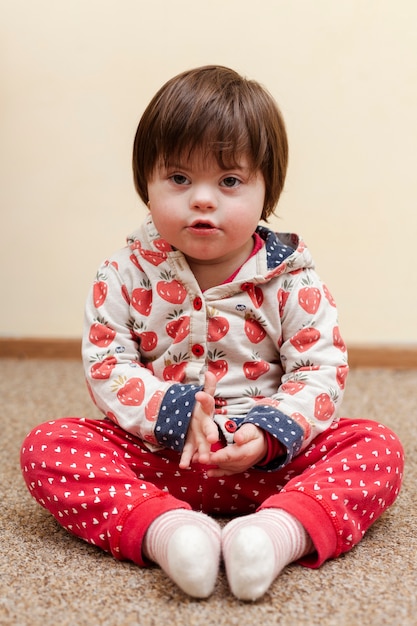 Photo front view of kid with down syndrome