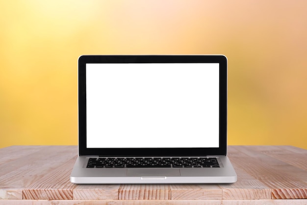 Front view of the laptop is on the work table with bokeh green background