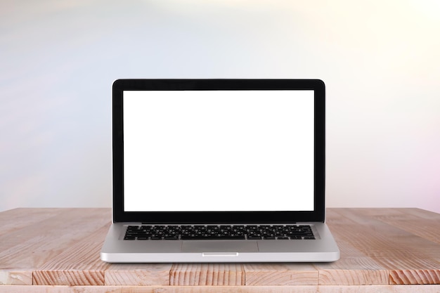 Front view of the laptop is on the work table with bokeh green background