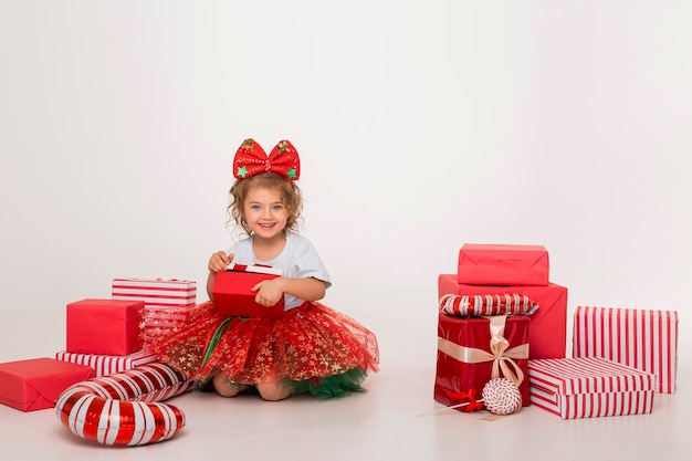 Front view little child surrounded by christmas elements