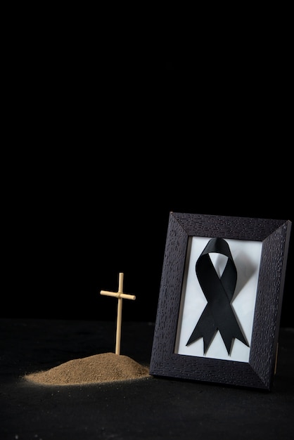 Photo front view of little grave with picture frame on black