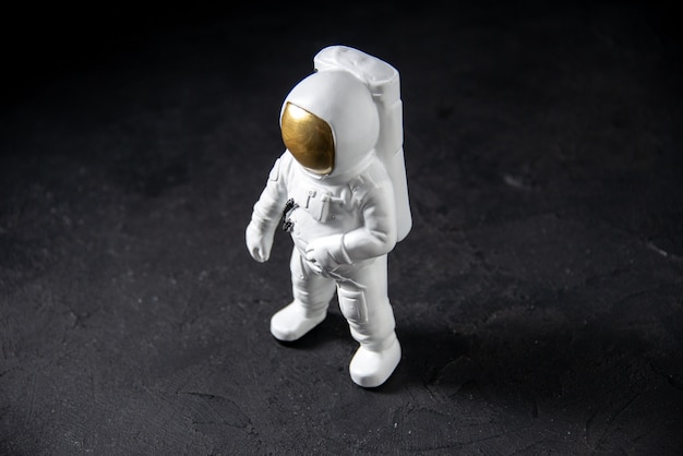 Front view of little spaceman toy on the black