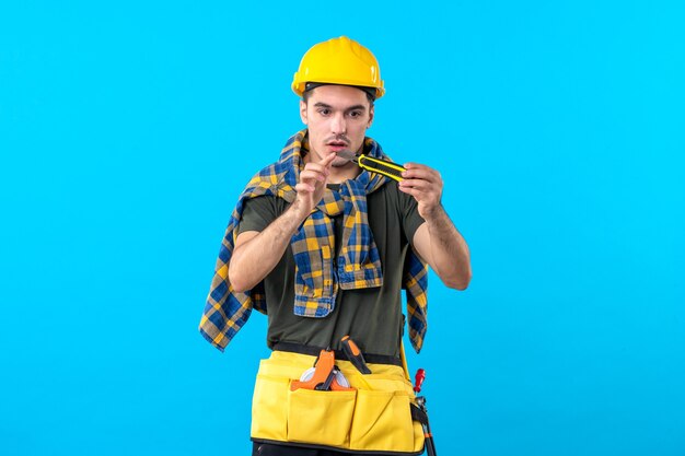 Front view male builder in helmet on the blue background builder flat architecture constructor house job building worker