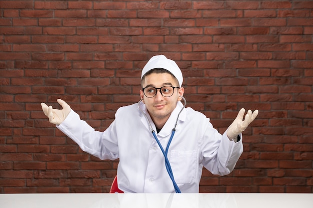 Front view male doctor in white medical suit with stethoscope