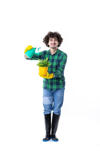 front view male gardener holding little plant on white background ground field job tree dig flower grass clean leaf